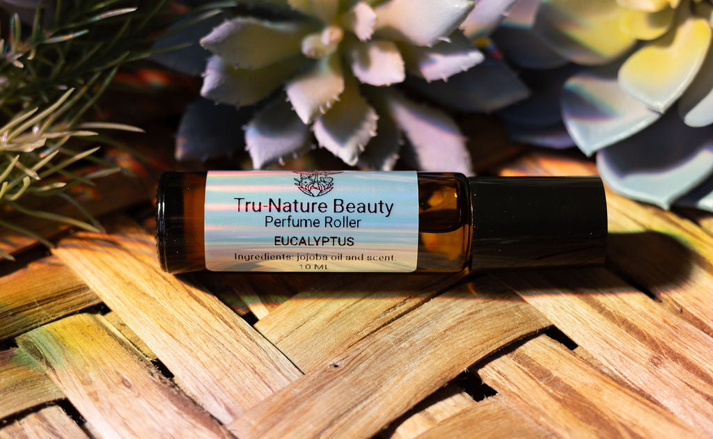 Tru-Nature Beauty Eucalyptus perfume roller on a woven surface with succulents in the background