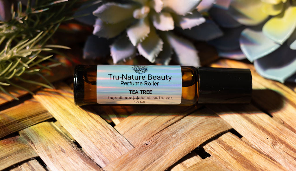 Tru-Nature Beauty perfume roller bottle on a wooden surface with plants in the background