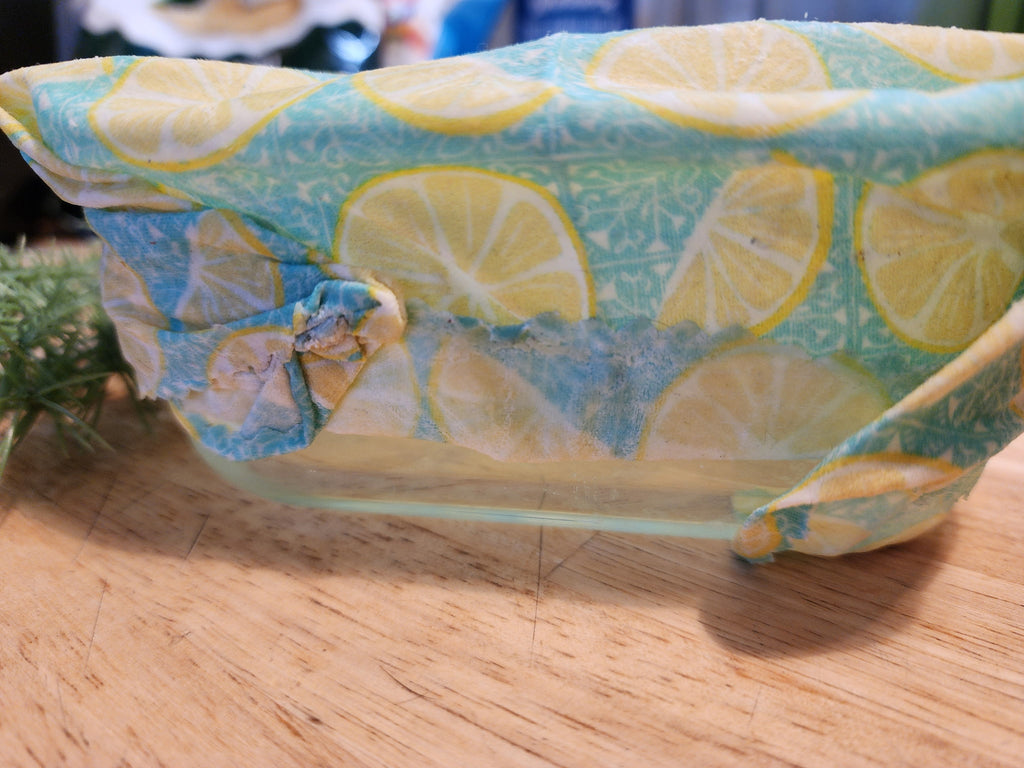 Fabric-wrapped object with lemon pattern on a wooden surface
