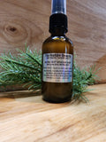 Bottle of Tru-Nature Beauty natural bug repellent on a wooden surface with greenery.
