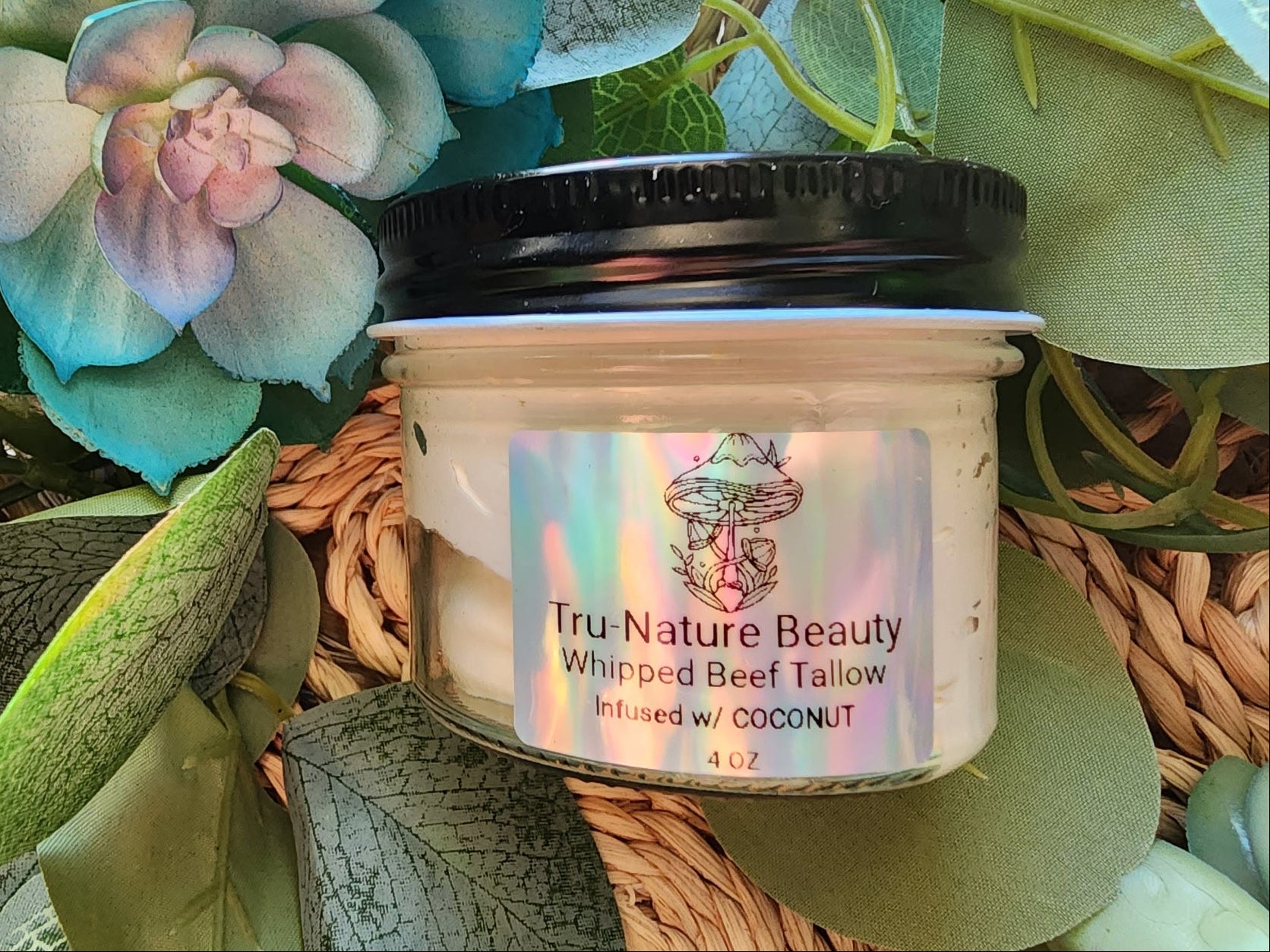 Jar of whipped body butter with a colorful label on a leafy background