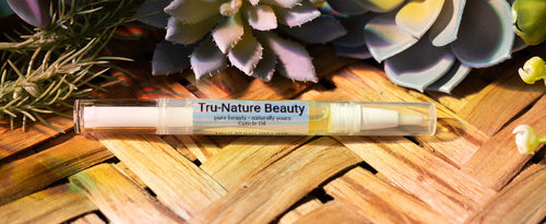 Tru-Nature Beauty product on a wooden surface with succulents in the background