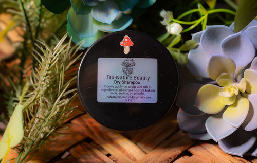 Tru-Nature Beauty dry shampoo container with a label on a decorative background of plants.