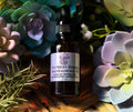 Bottle of Tru-Nature Beautiful Golden Glow Face Oil surrounded by succulent plants