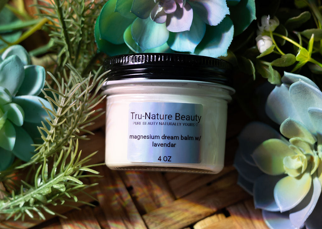 Tru-Nature Beauty magnesium balm jar surrounded by succulents on a wooden surface