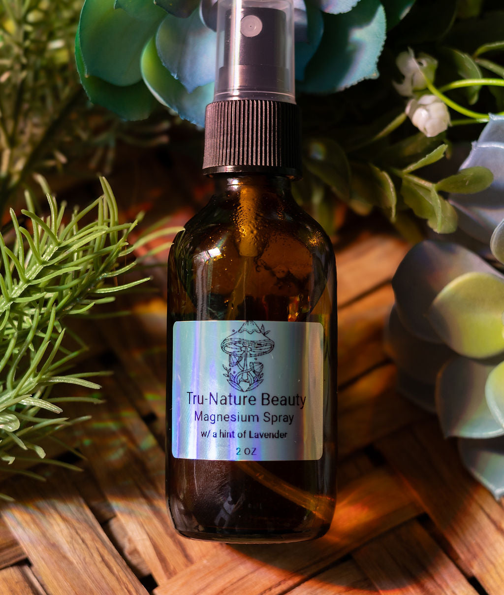 Brown glass bottle of Tru Nature Beauty Magnesium Spray with plants in the background