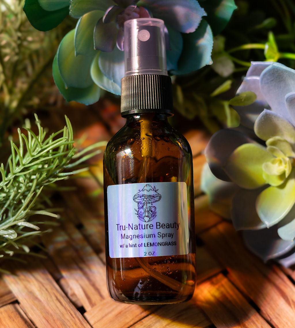 Brown glass bottle with a label on a wooden surface with plants in the background
