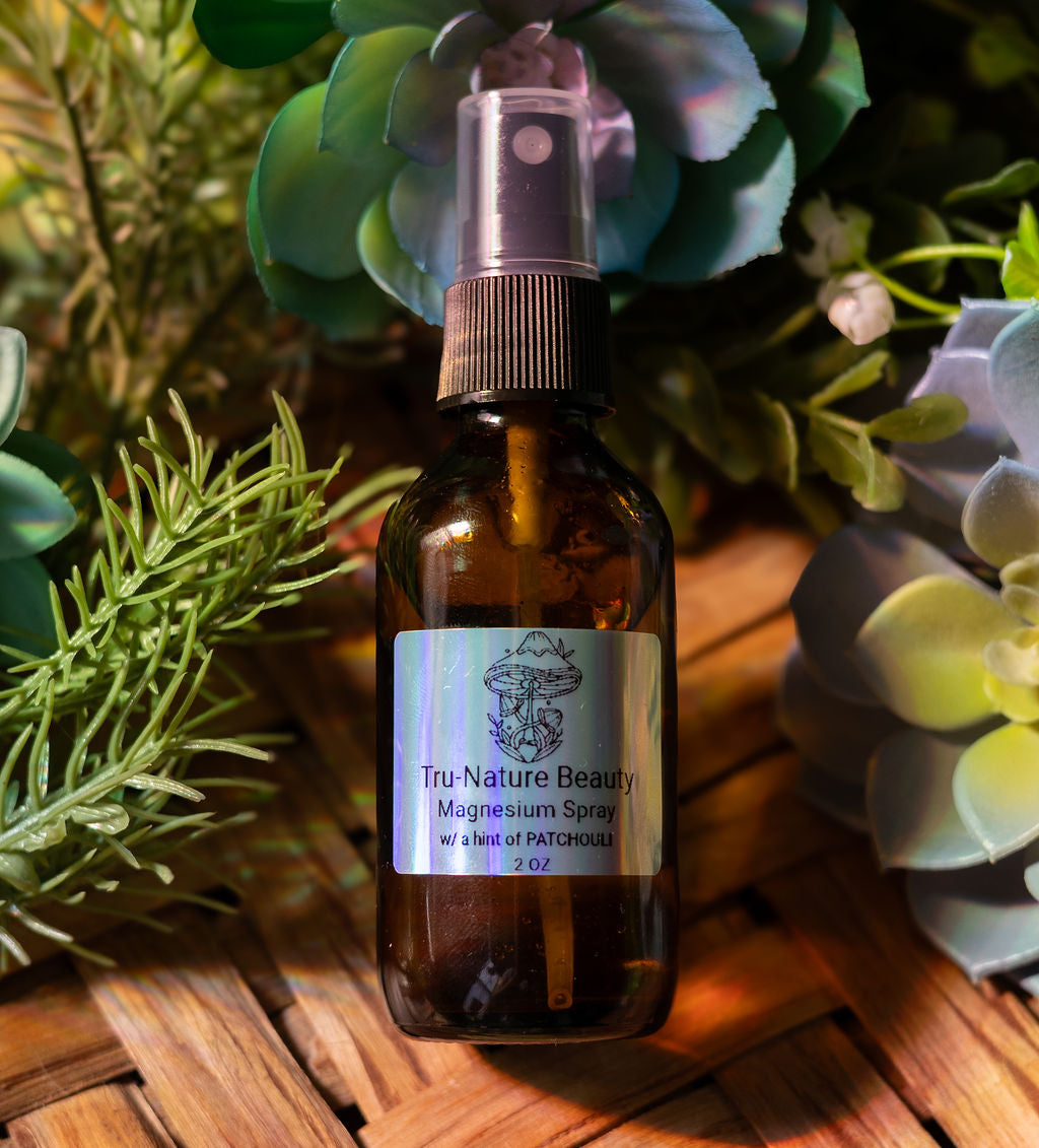 Brown spray bottle labeled 'Tru Nature Beauty' with green plants in the background