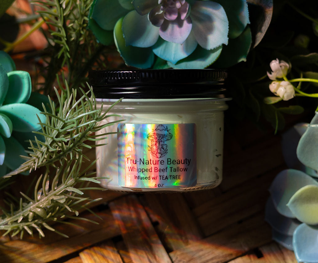 body and face lotion cream made from whipped beef tallow in a glass jar infused with tea tree oil