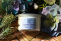 Glass jar of Tru-Nature Beauty product whipped beef tallow with decorative plants in the background