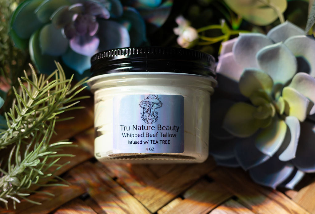Glass jar of Tru-Nature Beauty product whipped beef tallow with decorative plants in the background