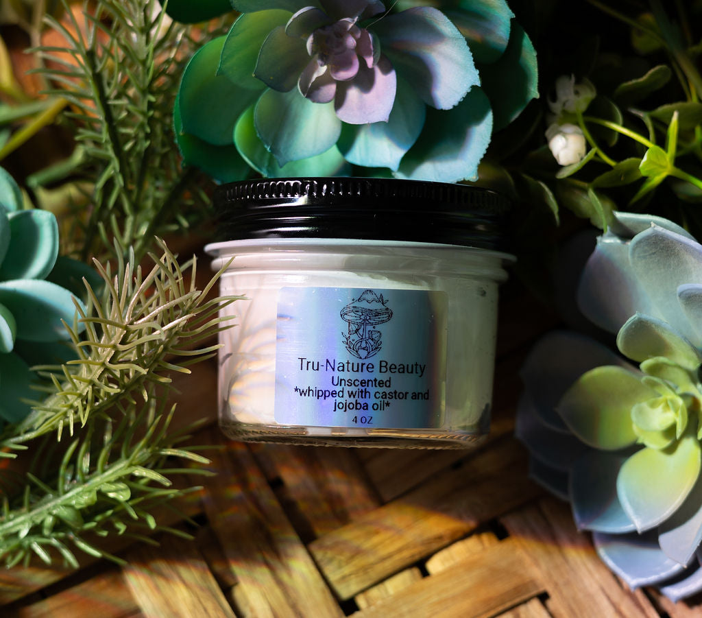 unscented whipped beef tallow with jojoba oil and castor oil in a glass container for body and face lotion